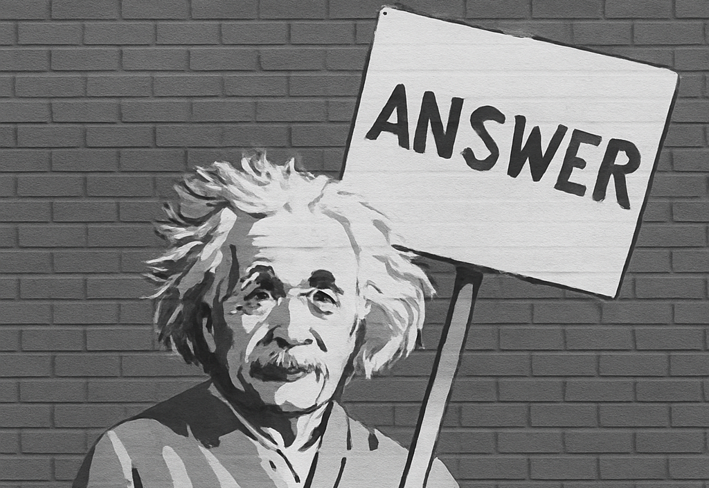Ilustración de Einstein sosteniendo un cartel con la palabra ANSWER, representando resolución de dudas